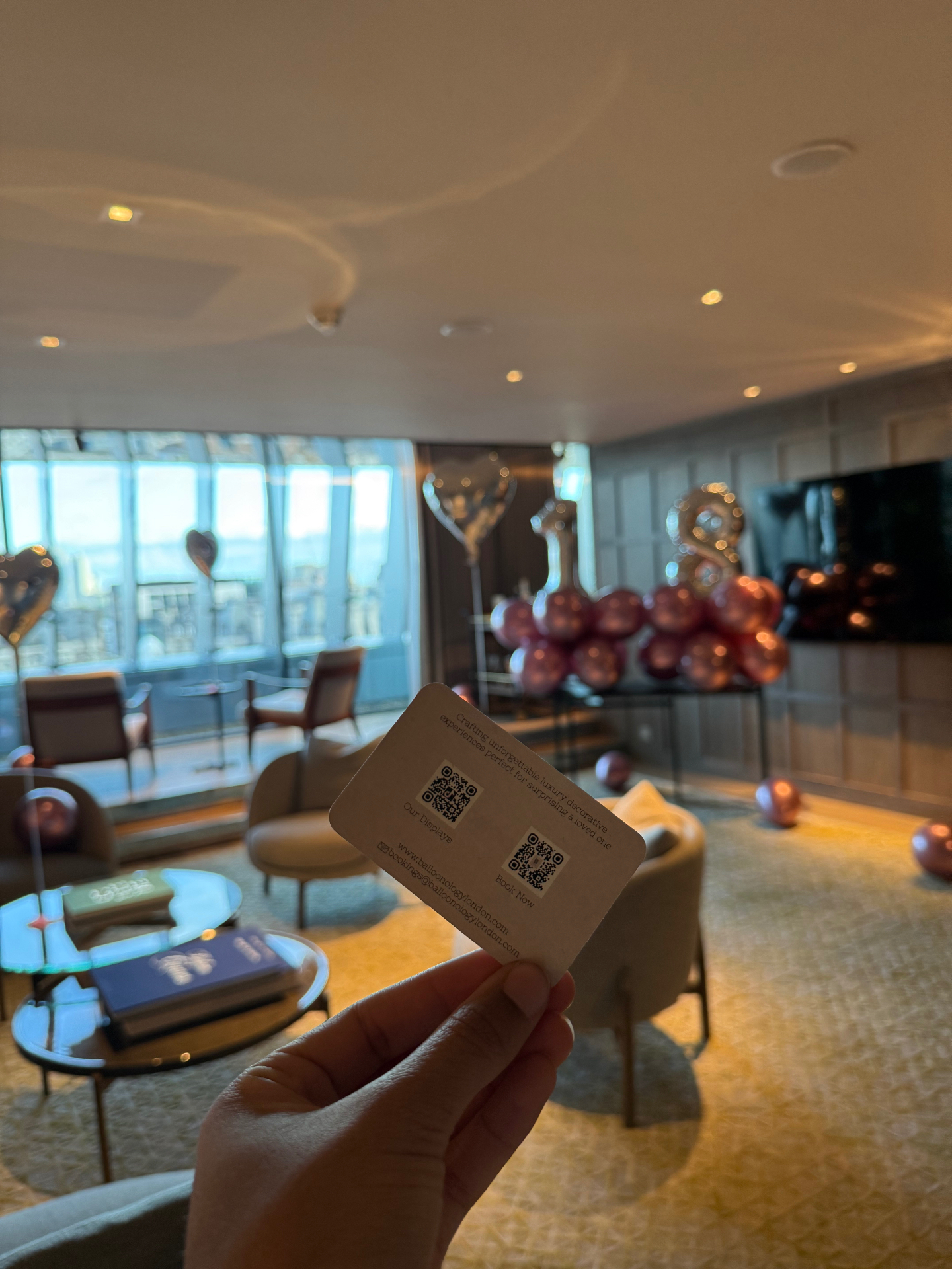 A London hotel suite with soft evening light and a wide city view.